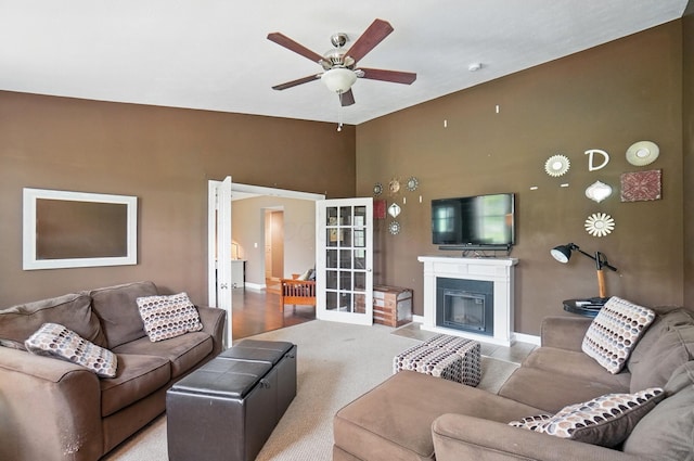 9820 Heimberger Rd NW, Baltimore, OH 43105 - living area featuring a ceiling fan, baseboards, a fireplace with flush hearth, and a towering ceiling