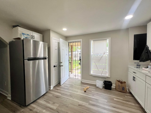 2624 Osceola Ave, Columbus, OH 43211 - kitchen featuring freestanding refrigerator, light wood finished floors, recessed lighting, white cabinets, and baseboards