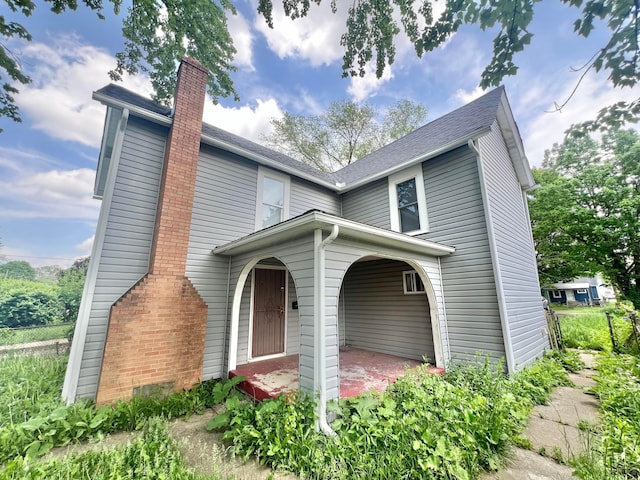 2624 Osceola Ave, Columbus, OH 43211 - traditional-style house with a chimney, covered porch, and roof with shingles