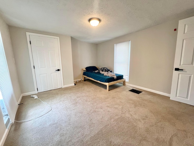 2624 Osceola Ave, Columbus, OH 43211 - carpeted bedroom with a textured ceiling and baseboards