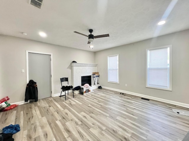 2624 Osceola Ave, Columbus, OH 43211 - living room featuring a fireplace, light wood-style flooring, baseboards, recessed lighting, and a ceiling fan