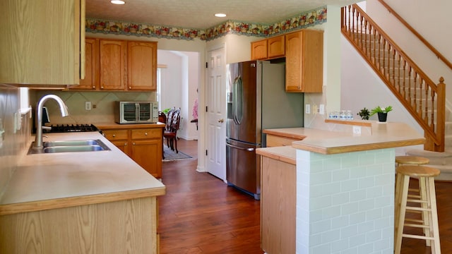 1908 Baltic Ave, Lewis Center, OH 43035 - kitchen with a sink, a peninsula, dark wood-type flooring, stainless steel refrigerator with ice dispenser, and light countertops