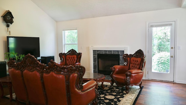 1908 Baltic Ave, Lewis Center, OH 43035 - living room featuring hardwood / wood-style floors, a tile fireplace, and lofted ceiling