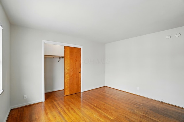 1476-1506 King Ave Unit 1476, Columbus, OH 43212 - unfurnished bedroom featuring light wood-type flooring, a closet, and baseboards