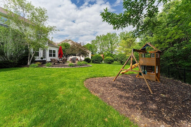view of yard featuring a patio and a playground