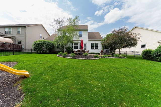 rear view of property with a playground