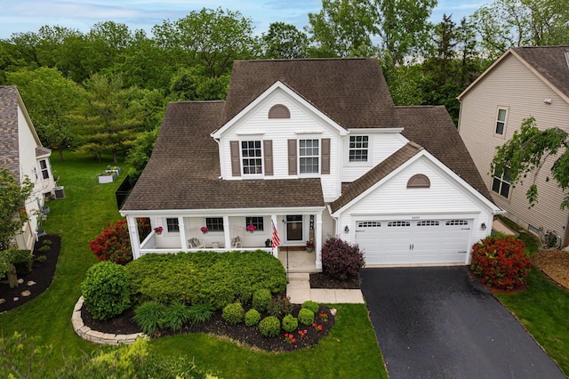 3409 Marl Pl, Columbus, OH 43221 - traditional-style house featuring driveway, a garage, a front yard, and a porch