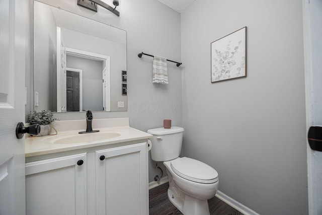 3409 Marl Pl, Columbus, OH 43221 - half bath featuring toilet, wood finished floors, vanity, and baseboards