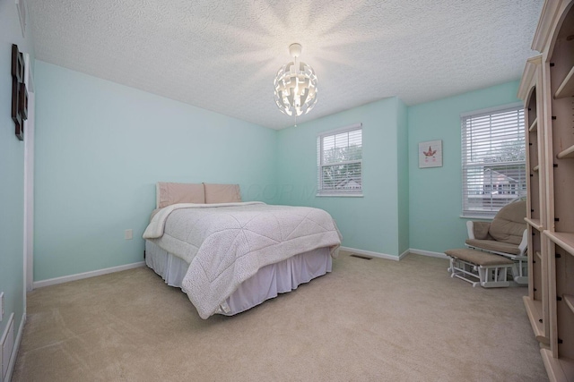 3409 Marl Pl, Columbus, OH 43221 - bedroom featuring a chandelier, light carpet, a textured ceiling, and baseboards