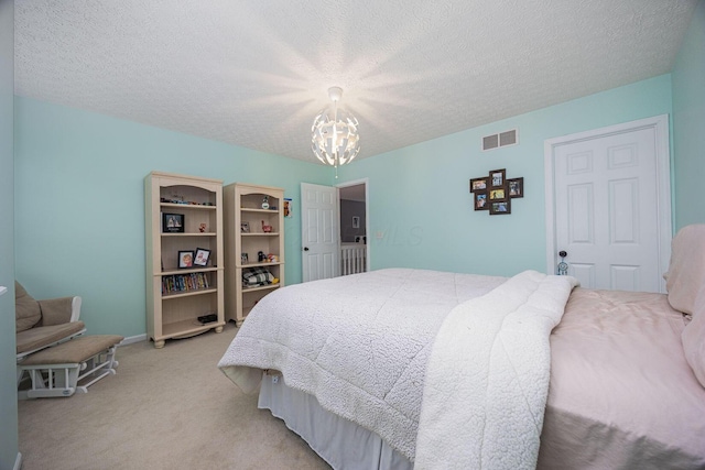 3409 Marl Pl, Columbus, OH 43221 - bedroom featuring a chandelier, light colored carpet, and a textured ceiling