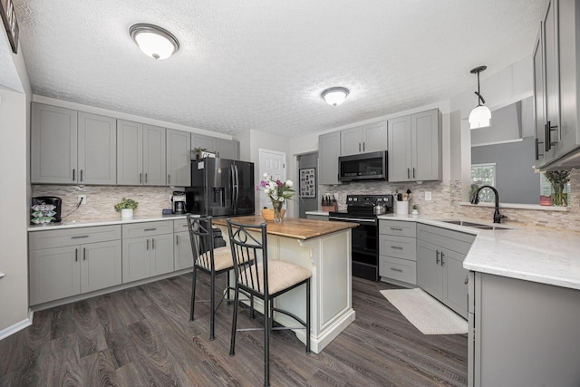 3409 Marl Pl, Columbus, OH 43221 - kitchen with black appliances, gray cabinets, a sink, dark wood-style floors, and a textured ceiling