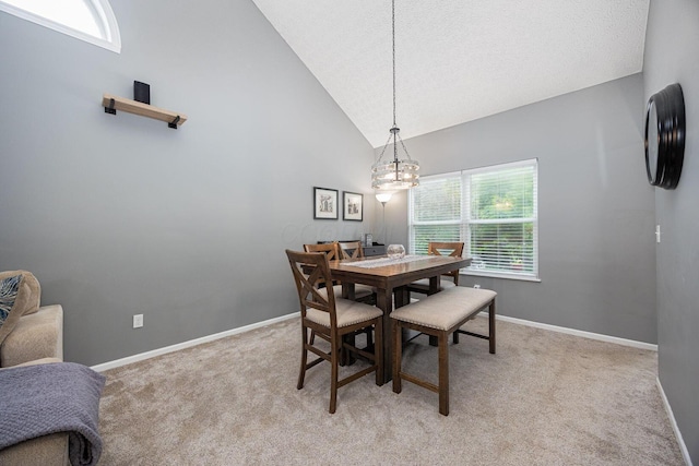 3409 Marl Pl, Columbus, OH 43221 - dining room featuring light colored carpet, a chandelier, baseboards, high vaulted ceiling, and a textured ceiling