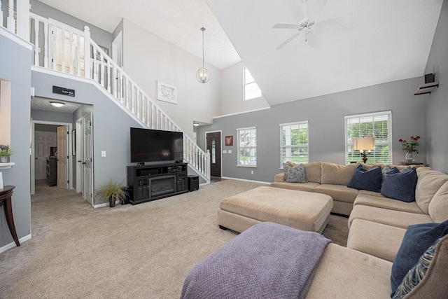 3409 Marl Pl, Columbus, OH 43221 - carpeted living room with stairs, high vaulted ceiling, a ceiling fan, and baseboards