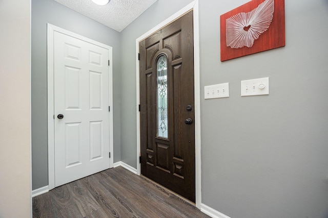 3409 Marl Pl, Columbus, OH 43221 - foyer with dark wood finished floors, baseboards, and a textured ceiling