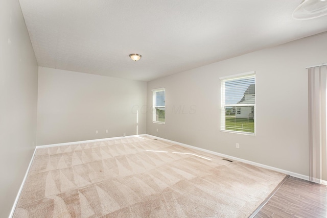 2357 Pine Crest Dr, Lancaster, OH 43130 - unfurnished room with baseboards, light wood-style floors, and light carpet