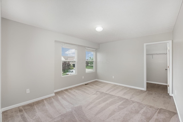 2357 Pine Crest Dr, Lancaster, OH 43130 - unfurnished bedroom with carpet, a spacious closet, baseboards, and a closet