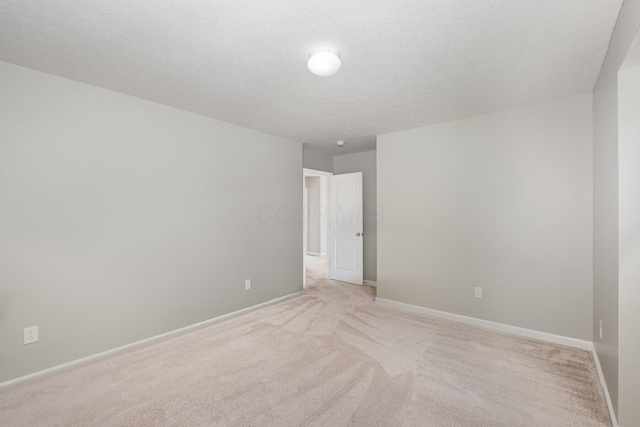 2357 Pine Crest Dr, Lancaster, OH 43130 - spare room featuring light carpet, baseboards, and a textured ceiling