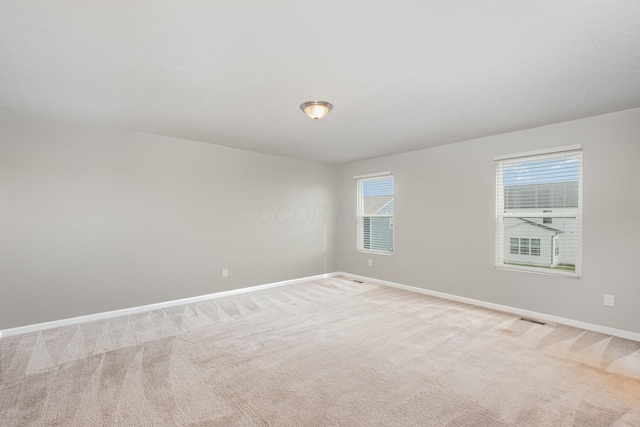 2357 Pine Crest Dr, Lancaster, OH 43130 - spare room featuring baseboards and light carpet