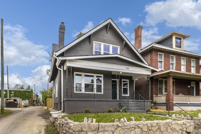 1104 E Whittier St, Columbus, OH 43206 - view of front of home with a porch, a chimney, and brick siding