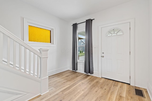 1104 E Whittier St, Columbus, OH 43206 - foyer with light wood-style floors, stairs, and baseboards