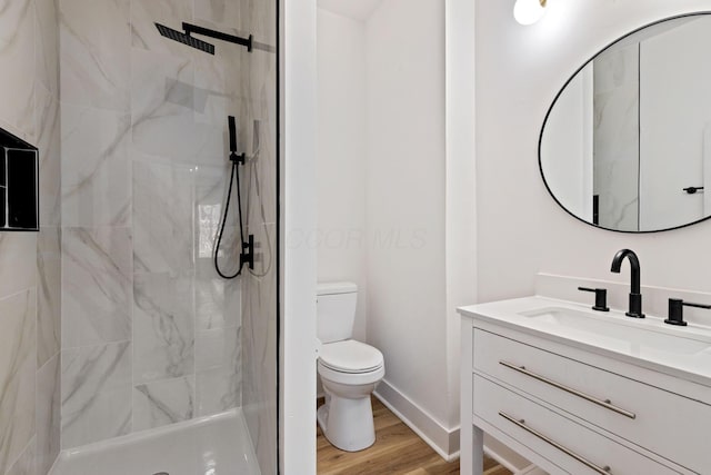 1104 E Whittier St, Columbus, OH 43206 - bathroom with toilet, vanity, a shower stall, wood finished floors, and baseboards