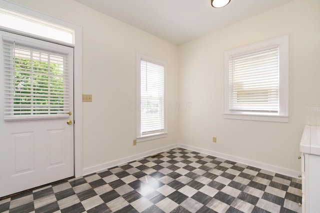 688 Hamlet St, Columbus, OH 43215 - doorway to outside featuring baseboards