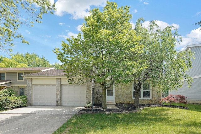 1711 Twin Oaks Dr, Powell, OH 43065 - obstructed view of property featuring a garage, stone siding, driveway, and a front yard