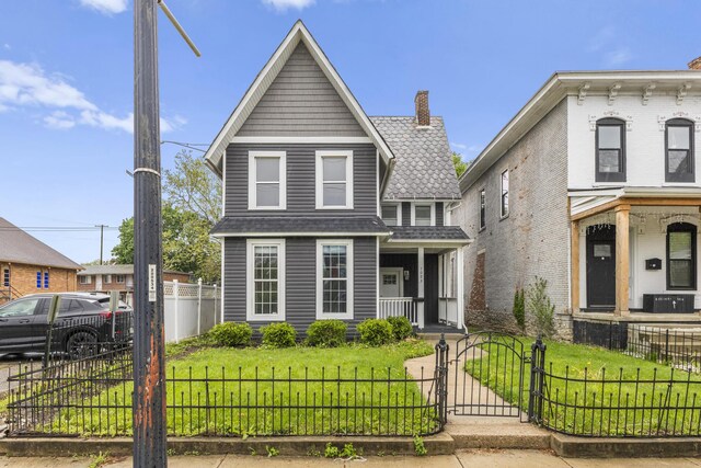 1093 E Long St, Columbus, OH 43203 - view of front of property featuring covered porch, a gate, and a chimney