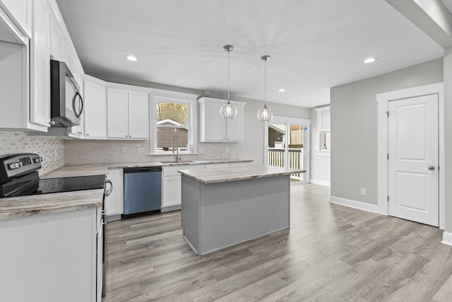 1093 E Long St, Columbus, OH 43203 - kitchen with stainless steel appliances, tasteful backsplash, a sink, white cabinets, and recessed lighting