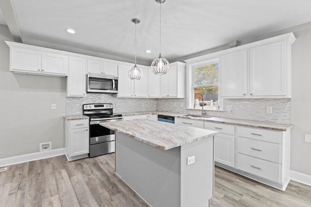 1093 E Long St, Columbus, OH 43203 - kitchen featuring appliances with stainless steel finishes, white cabinetry, light wood-style flooring, and recessed lighting