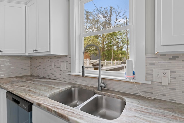 1093 E Long St, Columbus, OH 43203 - kitchen featuring a sink, dishwashing machine, backsplash, white cabinetry, and light stone counters