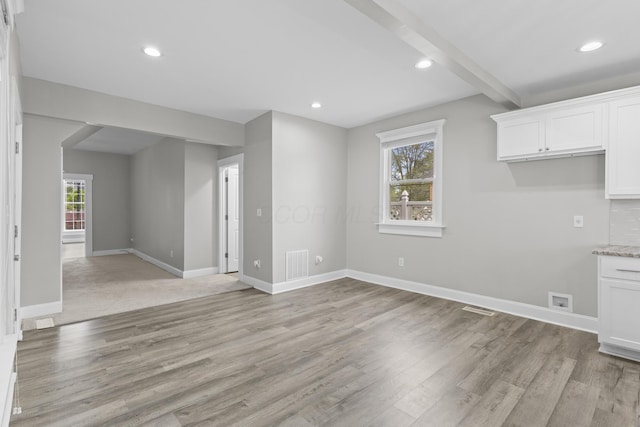1093 E Long St, Columbus, OH 43203 - kitchen featuring light wood-type flooring, white cabinets, baseboards, beam ceiling, and recessed lighting