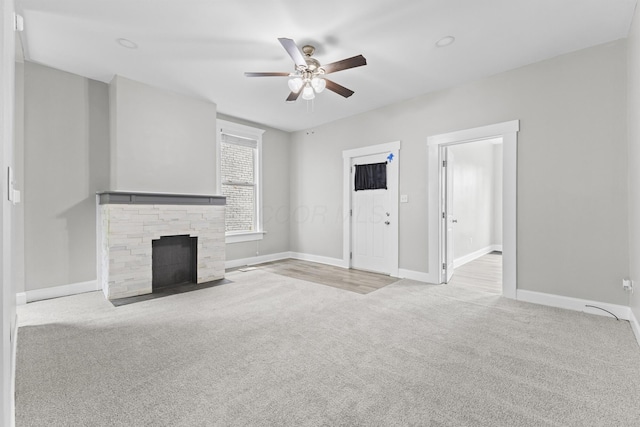 1093 E Long St, Columbus, OH 43203 - unfurnished living room with carpet flooring, ceiling fan, baseboards, and a fireplace