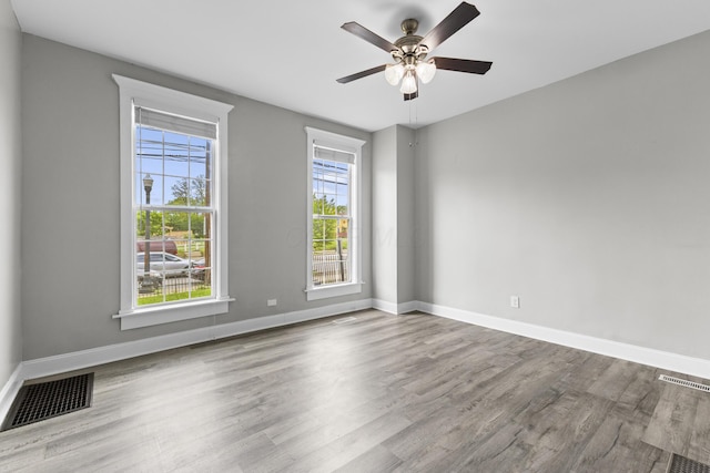 1093 E Long St, Columbus, OH 43203 - unfurnished room with wood finished floors, baseboards, and a ceiling fan