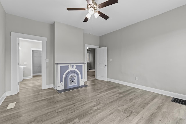 1093 E Long St, Columbus, OH 43203 - unfurnished living room with wood finished floors, ceiling fan, and baseboards
