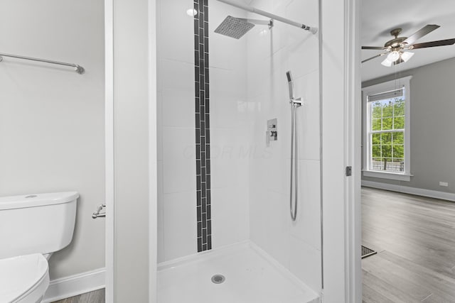1093 E Long St, Columbus, OH 43203 - bathroom with toilet, a shower stall, baseboards, and ceiling fan