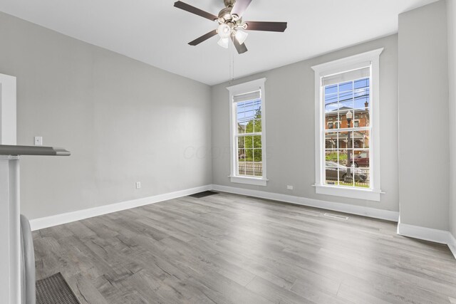 1093 E Long St, Columbus, OH 43203 - spare room featuring wood finished floors, baseboards, and a ceiling fan
