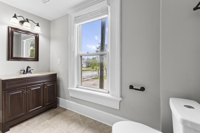 1093 E Long St, Columbus, OH 43203 - bathroom featuring toilet, tile patterned floors, vanity, and baseboards