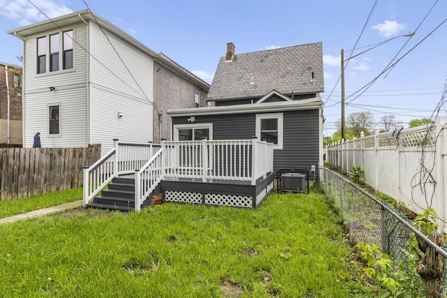 1093 E Long St, Columbus, OH 43203 - rear view of property with a deck, a chimney, and central AC