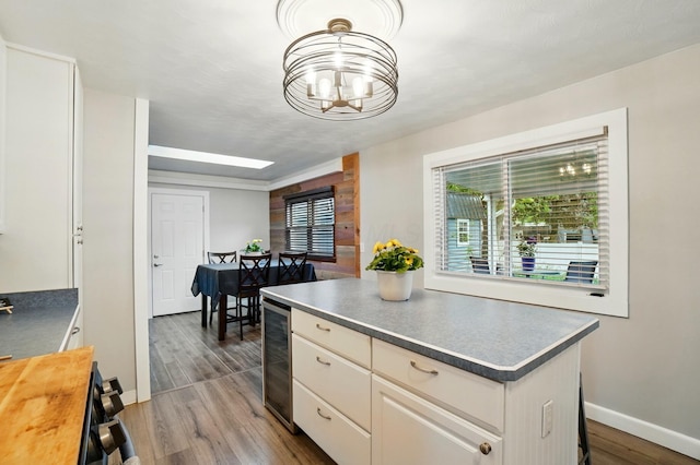 1008 London Rd, West Jefferson, OH 43162 - kitchen featuring baseboards, beverage cooler, a chandelier, a center island, and dark wood-type flooring