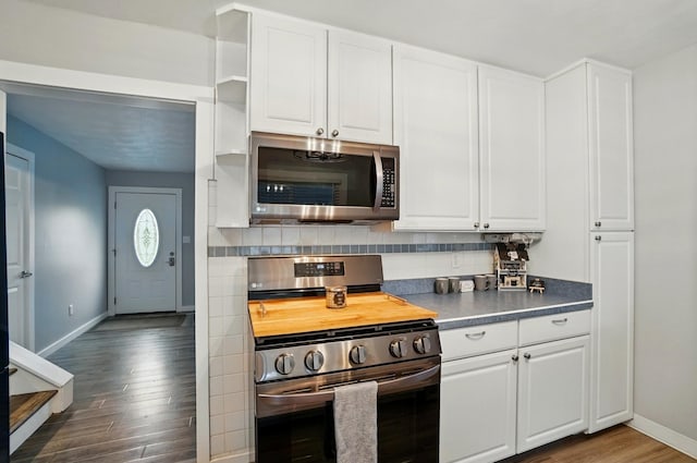 1008 London Rd, West Jefferson, OH 43162 - kitchen featuring stainless steel appliances, dark wood-style flooring, baseboards, white cabinets, and decorative backsplash