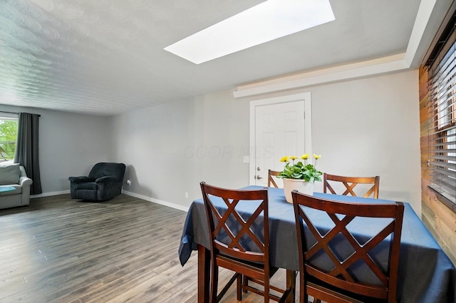 1008 London Rd, West Jefferson, OH 43162 - dining area with a skylight, baseboards, and wood finished floors