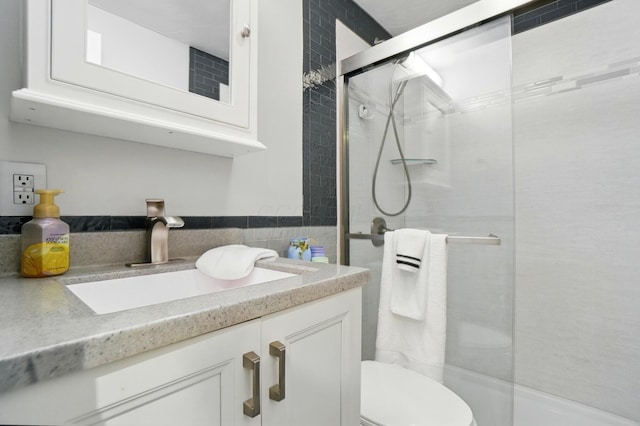 1008 London Rd, West Jefferson, OH 43162 - full bath featuring vanity, a shower with shower door, toilet, and tile walls