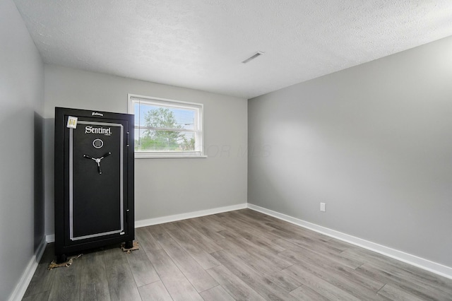 1008 London Rd, West Jefferson, OH 43162 - spare room with wood finished floors, a textured ceiling, and baseboards