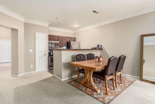 6077 Craughwell Ln, Dublin, OH 43017 - dining room featuring crown molding, light carpet, and baseboards