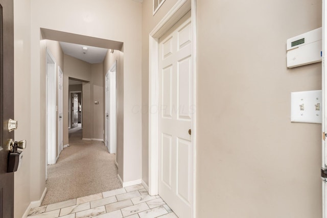 6077 Craughwell Ln, Dublin, OH 43017 - hallway featuring baseboards and light colored carpet