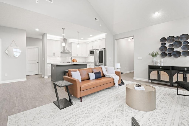5165 Hamptonshire Dr, Dublin, OH 43016 - living room with light wood-type flooring, baseboards, recessed lighting, and vaulted ceiling