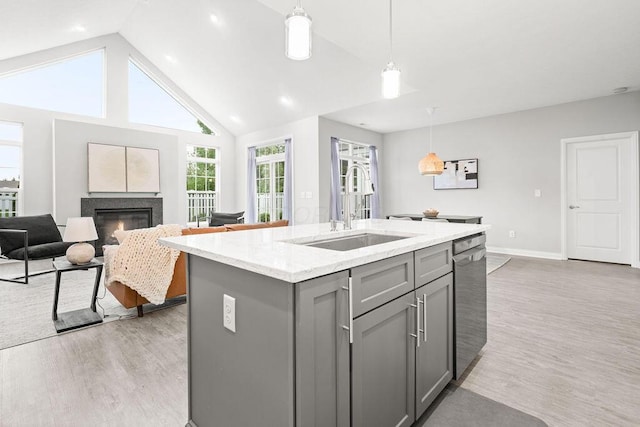 5165 Hamptonshire Dr, Dublin, OH 43016 - kitchen featuring gray cabinets, a sink, light wood-type flooring, stainless steel dishwasher, and light stone countertops