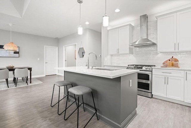 5165 Hamptonshire Dr, Dublin, OH 43016 - kitchen featuring wall chimney range hood, double oven range, a sink, backsplash, and a breakfast bar