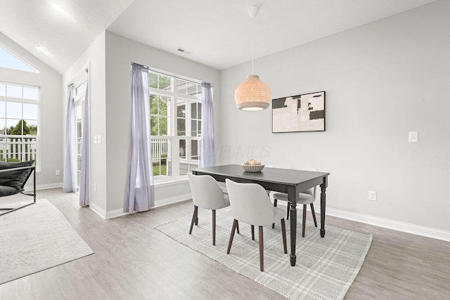 5165 Hamptonshire Dr, Dublin, OH 43016 - dining space featuring wood finished floors, baseboards, and lofted ceiling